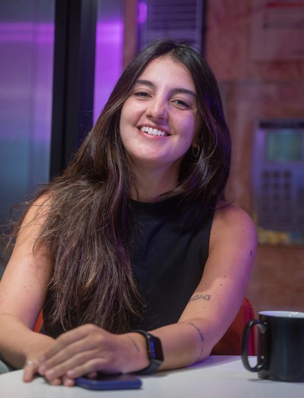 A young female ByteDance employee with long brown hair smiling.